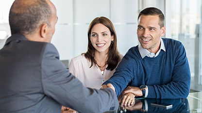 Businessman shaking hands with clients Businessman shaking hands with clients
