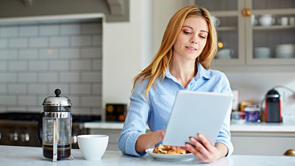 Lady using tablet in kitchen Lady using tablet in kitchen