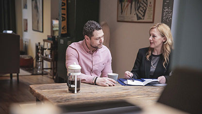 Man and Relationship Manager meeting over coffee