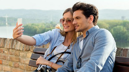 Couple on holiday taking photograph Couple on holiday taking photograph