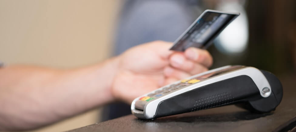 Card payment machine Couple paying in cafe