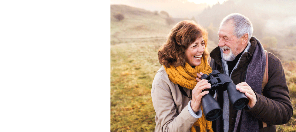 Mature couple using binoculars Mature couple using binoculars