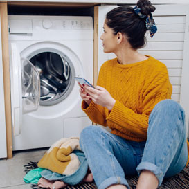 lady checking eco label on washing machine