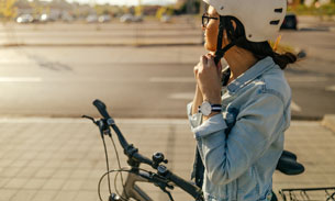 lady putting on bike helmet