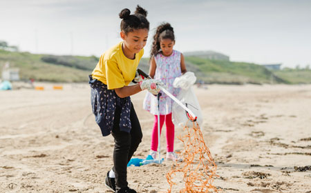 two young beach cleaners