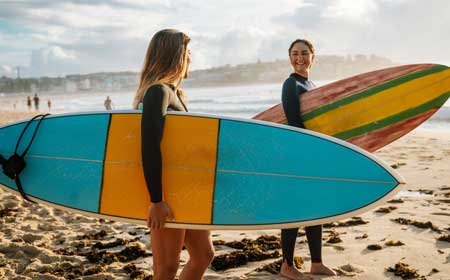 two ladies with surf boards