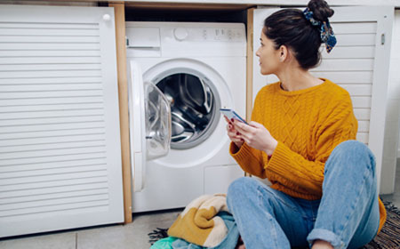 lady checking washing machine is eco friendly