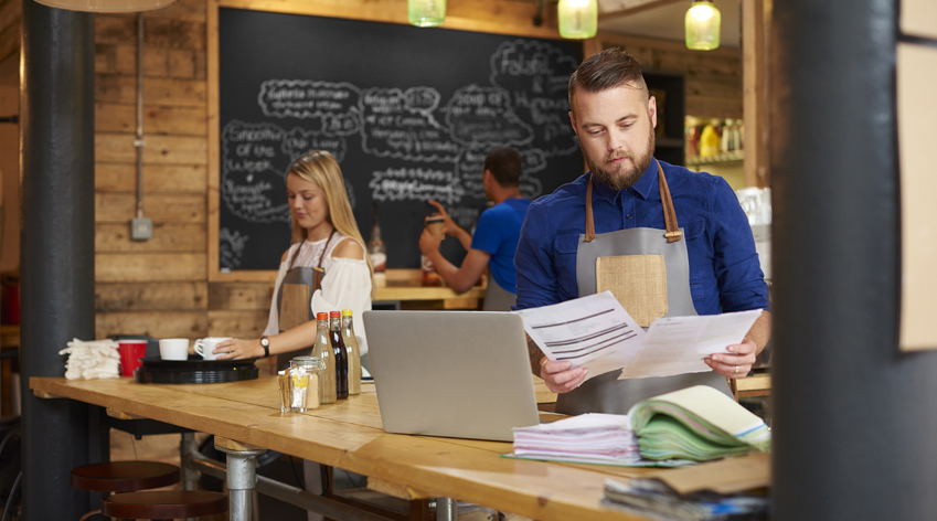 Coffee shop owner doing calculations